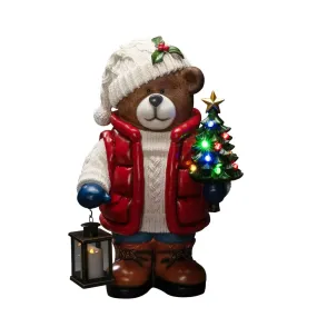 Grote Teddybeer 66cm Veelkleurig Van Konstsmide - Er staat een felverlichte kerstboom en een lantaarn in, wat voor een gezellige sfeer zorgt.