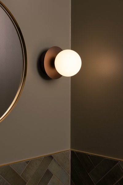 Art Deco Ø16 Brons/wit badkamerlamp Van Globen Lighting - De lamp is gemaakt van metaal en heeft een witte glazen kap die zorgt voor een mooie lichtspreiding in de kamer.