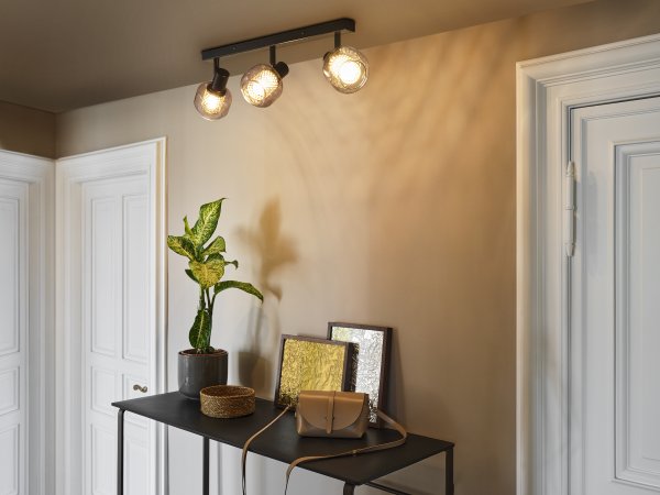 Firefly 3 Zwart spot Van Osram - De r&ouml;rliga spotlightsen med sk&auml;rmar av gr&aring;tonat glas i kombination med de guldiga detaljh&ouml;ljet som omfamnar ljusk&auml;llorna bidrar med en elegans till rummet.