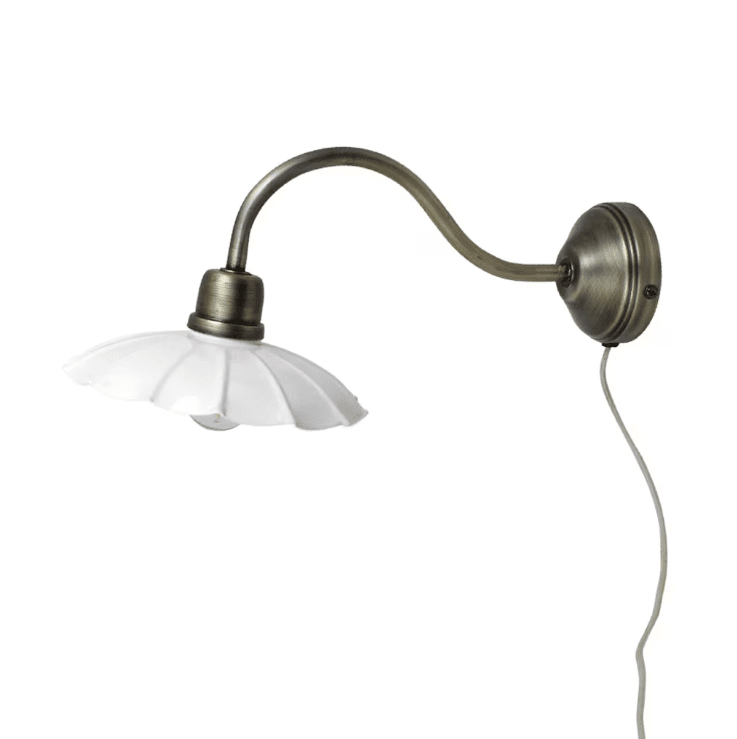 Gustav Ø20 Wit/antiek messing wandlamp Van Strömshaga - De antieke messing afwerking is gecombineerd met een wit gelakte metalen kap met een prachtig golvende rand, wat een zachte en stijlvolle uitstraling geeft.