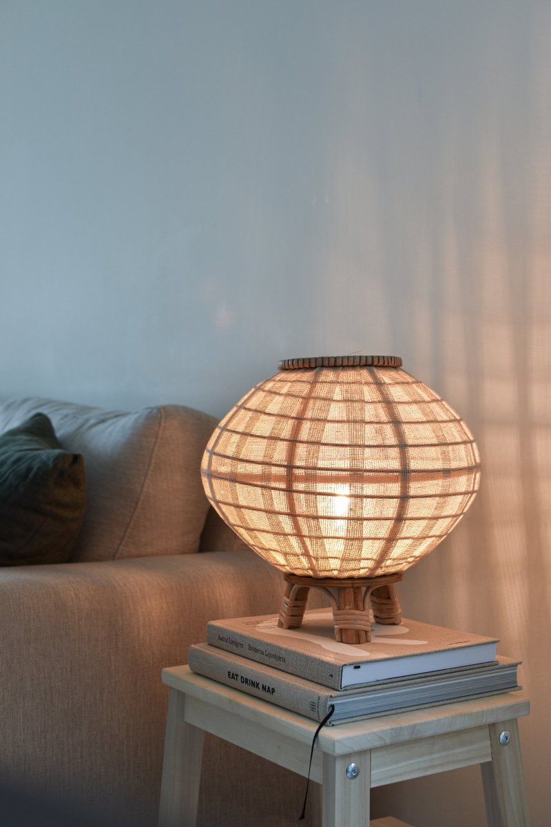 Borneo 37cm Natuur tafellamp Van Globen Lighting - De lamp is gemaakt van naturelkleurig rotan en gebroken wit linnen en heeft een 200 cm lang wit textielsnoer met schakelaar en stekker.