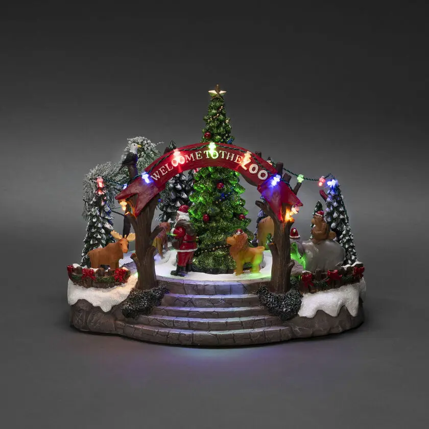 Mechanische Kerstdecoratie Met Dierentuin 20cm Veelkleurig Van Konstsmide - Deze mechanische kerstversiering biedt een kleurrijk tafereel met 19 warmwitte LED-lampjes, muziek, dieren en de Kerstman rond een fonkelende kerstboom.