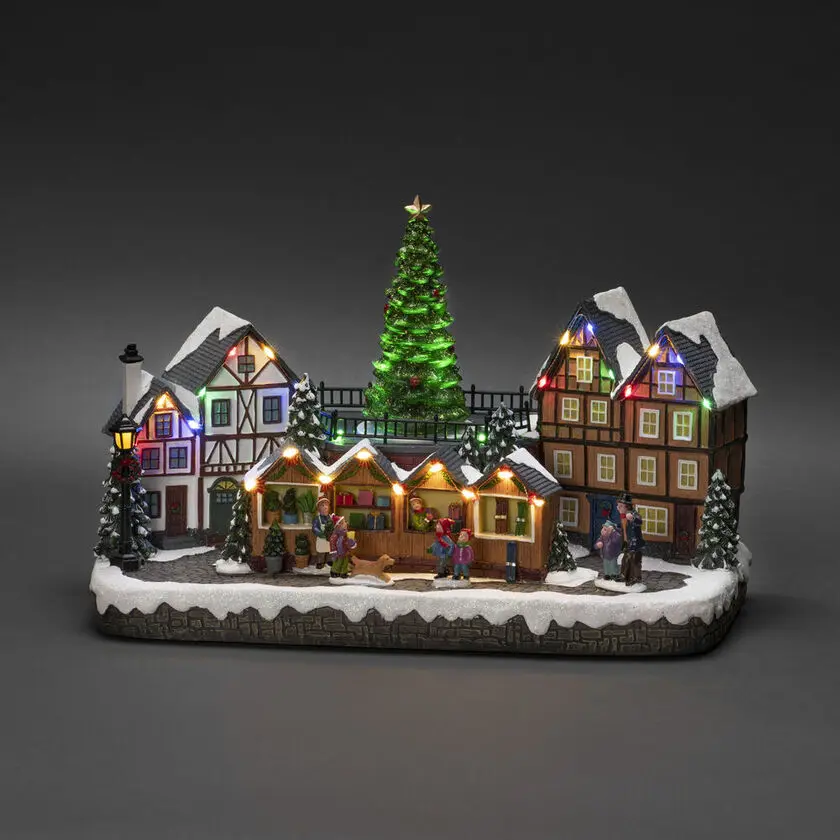 Mechanische Kerstdecoratie Met Kerstmarkt 24cm Veelkleurig Van Konstsmide - Met 28 warmwitte LED-lampjes, met sneeuw bedekte huizen, kleurrijke marktkraampjes en een statige kerstboom in het midden verspreidt het zowel licht als muziek.