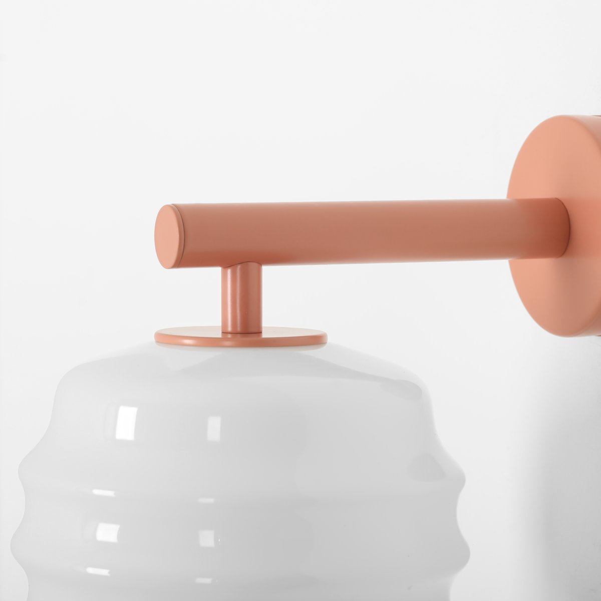 Puff 23cm Koraal wandlamp Van Artera - De koraalroze metalen details vormen een mooi contrast met het lichte glas en geven de lamp een warme uitstraling.
