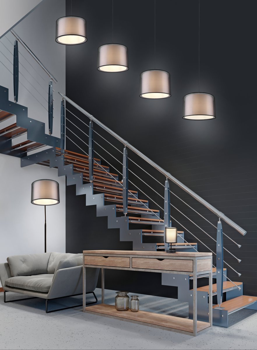 Burton Zwart vloerlamp Van Trio Lighting - De moderne combinatie van een witte stoffen binnenkap en een transparante zwarte kunststof buitenkap ziet er individueel en verfrissend uit en past perfect in een moderne levensstijl.