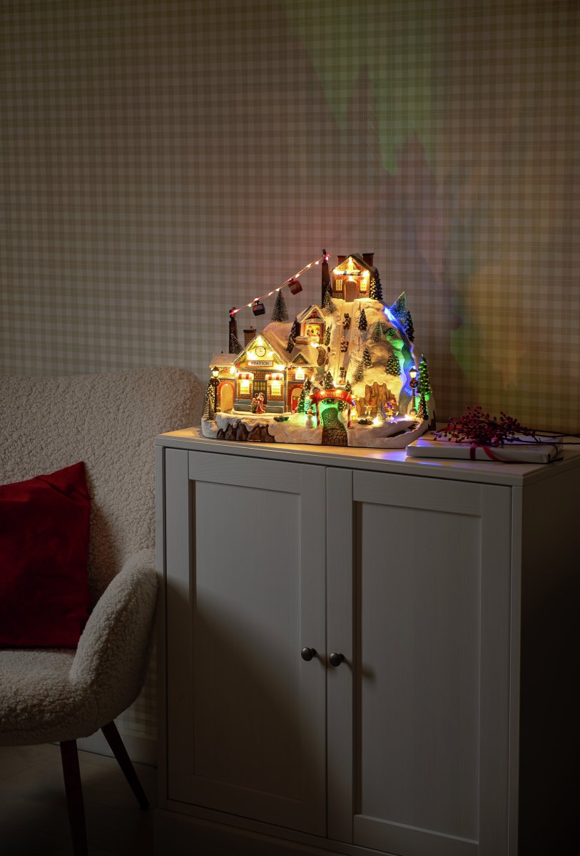 Kerstdorp Skigebied 28cm Veelkleurig Van Konstsmide - Het kerstdorp werkt op 3 AA-batterijen (niet meegeleverd) en wordt geleverd met een USB-kabel voor gebruik met een snoer (transformator niet meegeleverd).