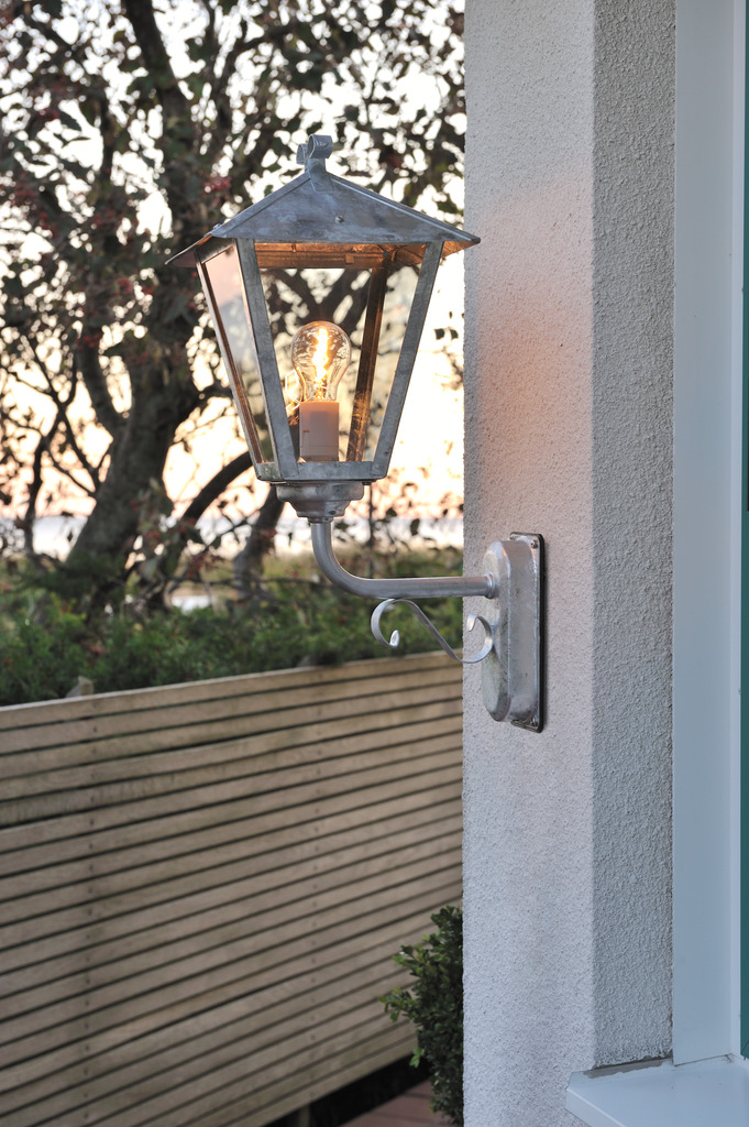 Benu Gegalvaniseerd staal buitenlamp Van Konstsmide - De klassieke lantaarnvorm en de robuuste materialen van de lamp maken hem tot een perfecte keuze voor wie een uitnodigende sfeer wil cre&euml;ren in entrees of lange gangen.