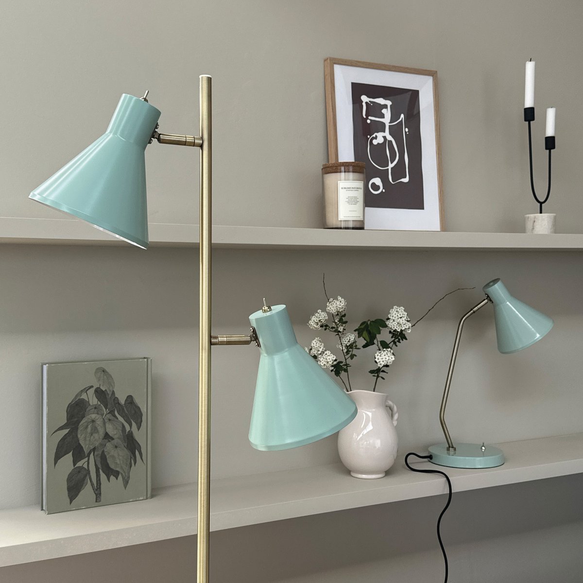 Sleep Glanzende munt vloerlamp Van Dyberg Larsen - De mintgroene kleur geeft de lamp een retro-look, terwijl de antieke messing details een elegante toets toevoegen.