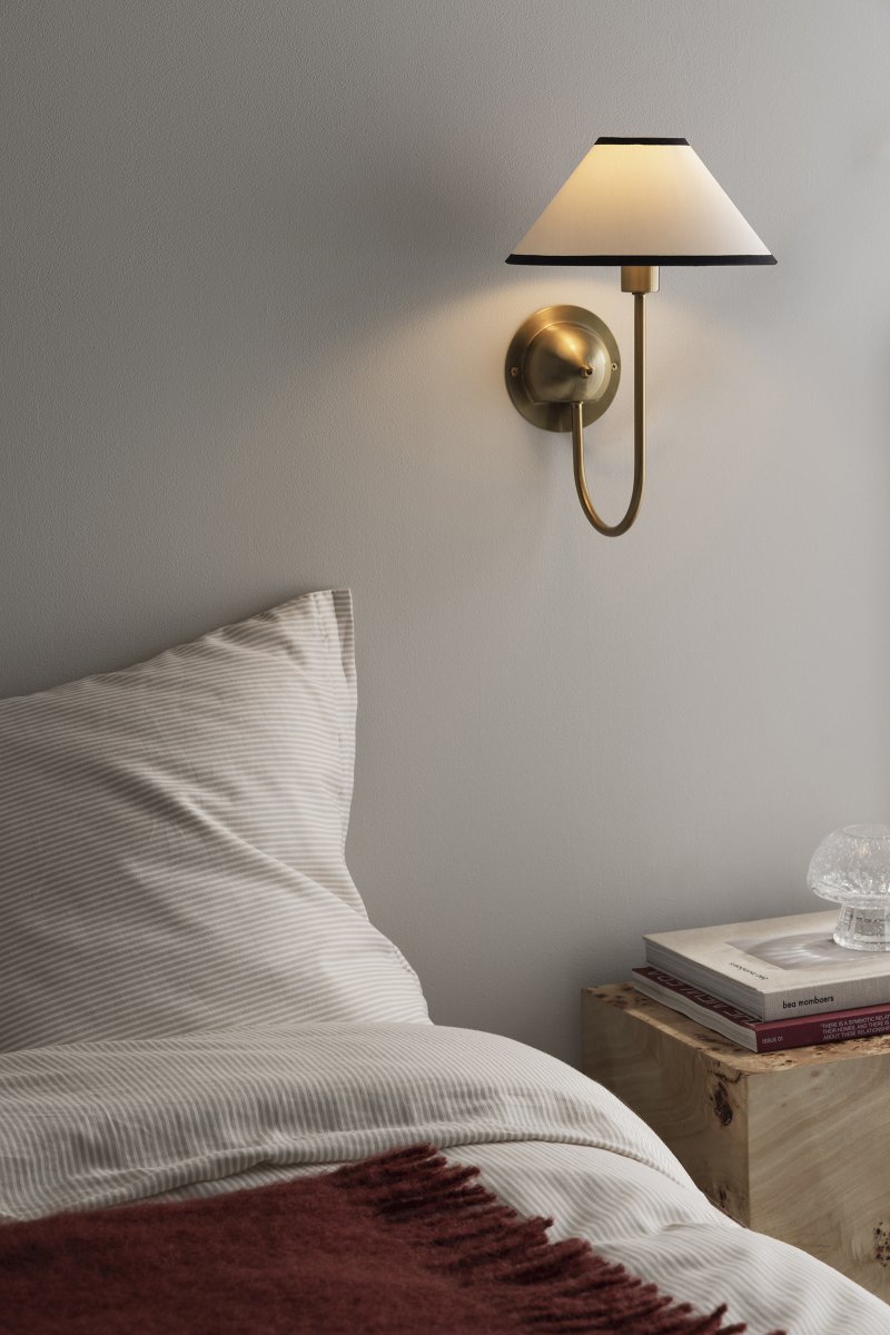 Iris 32cm Messing/crème wit wandlamp Van Globen Lighting - De zacht gebogen arm is gecombineerd met een crèmekleurige textielen kap, wat zorgt voor een warme en klassieke uitstraling.