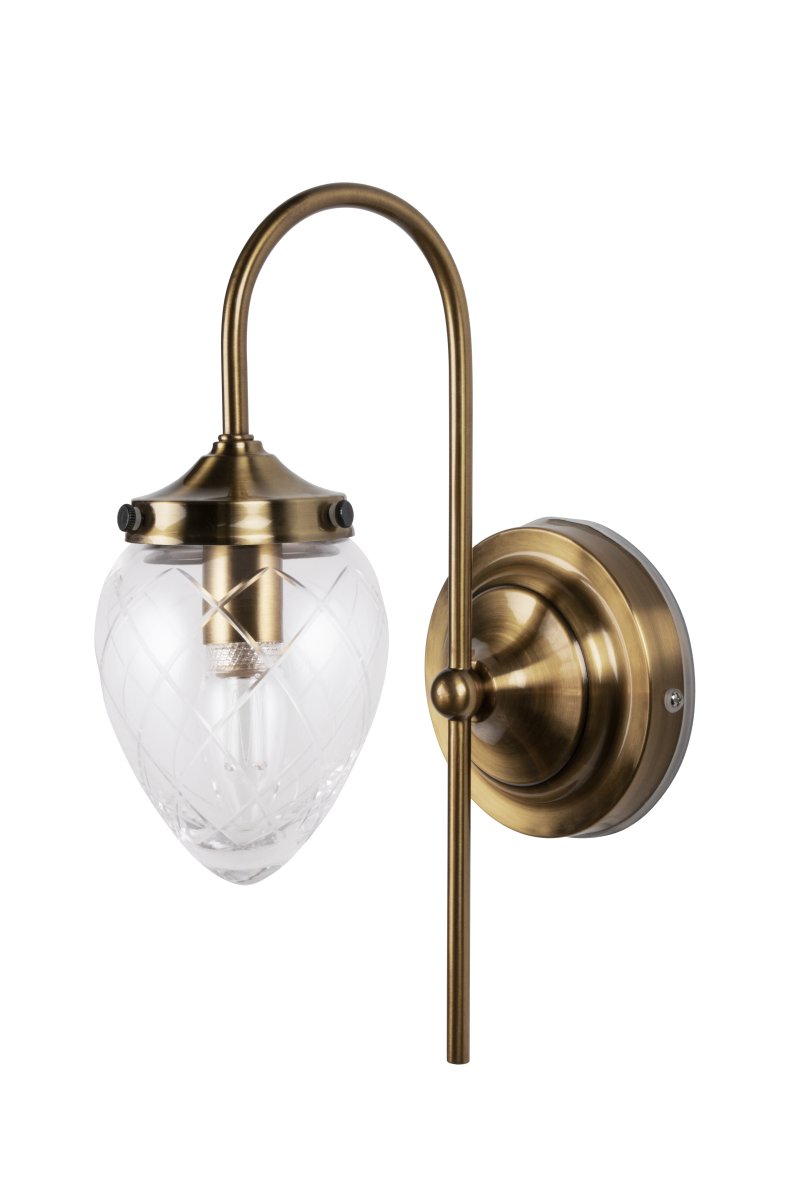 Juni 24cm Antiek messing/transparant badkamerlamp Van Globen Lighting - Juni met zijn prachtige geslepen glas en metalen kap neemt je mee terug in de tijd naar het begin van de 20e eeuw.