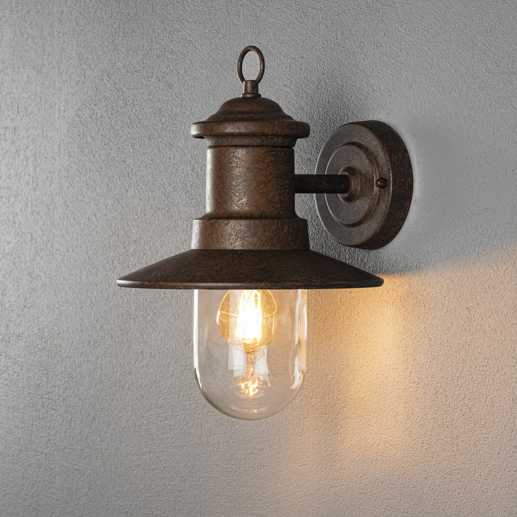 Napoli Roest buitenlamp Van Konstsmide - Het klassieke ontwerp van de lamp met een ronde glazen koepel en een brede kap verspreidt een warm en aangenaam licht, ideaal voor het verlichten van entrees en terrassen.