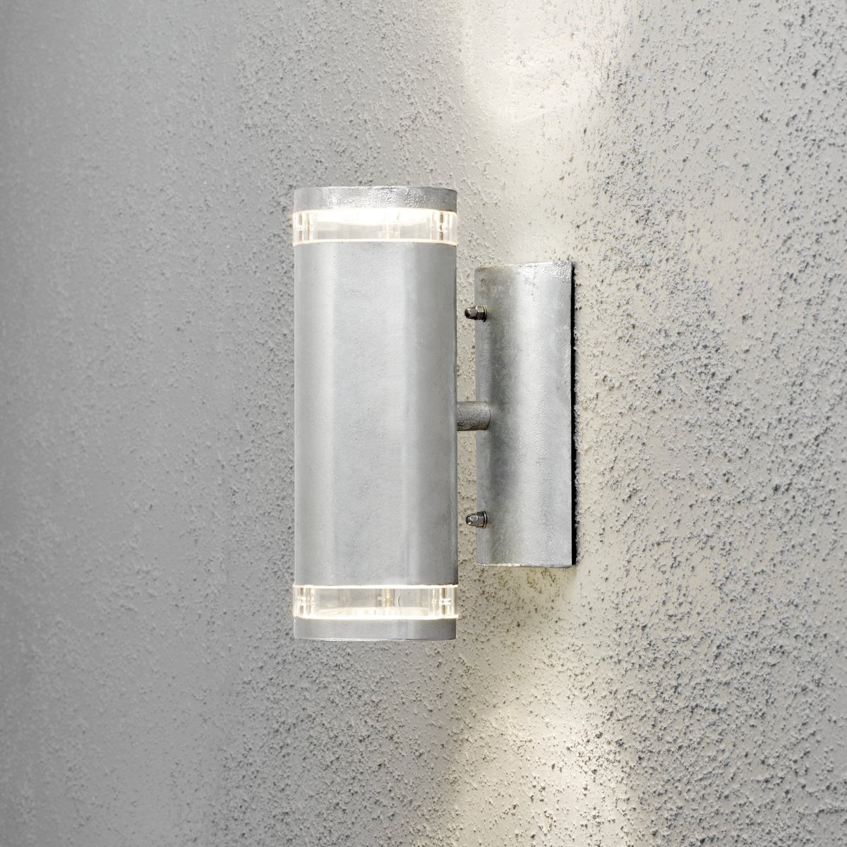 Modena II Gegalvaniseerd buitenlamp Van Konstsmide - Het licht wordt zowel naar boven als naar beneden gericht en cre&euml;ert een decoratief en effectief lichtbeeld dat de gevel verfraait en de tuin een uitnodigende sfeer geeft.