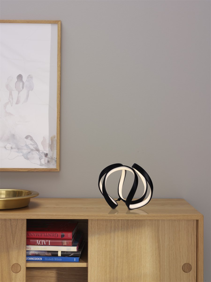 Wave 18cm Zwart tafellamp Van Cottex - Wave bordslampa i metall och silikon &auml;r en modern och elegant belysningsl&ouml;sning som ger ditt rum en unik och stilfull k&auml;nsla.