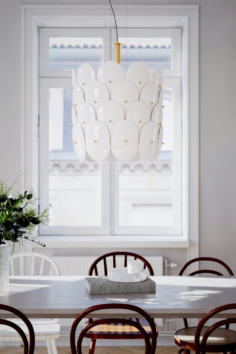 Omlott Ø50 Wit hanglamp Van By Rydéns - Er zit een prachtige hanger omheen gewikkeld en met de messing details voegt het elegantie toe aan de kamer.